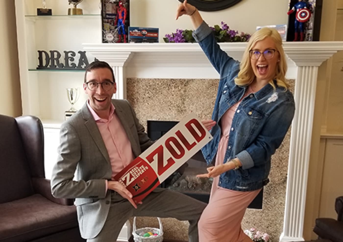 Happy couple with a SOLD sign